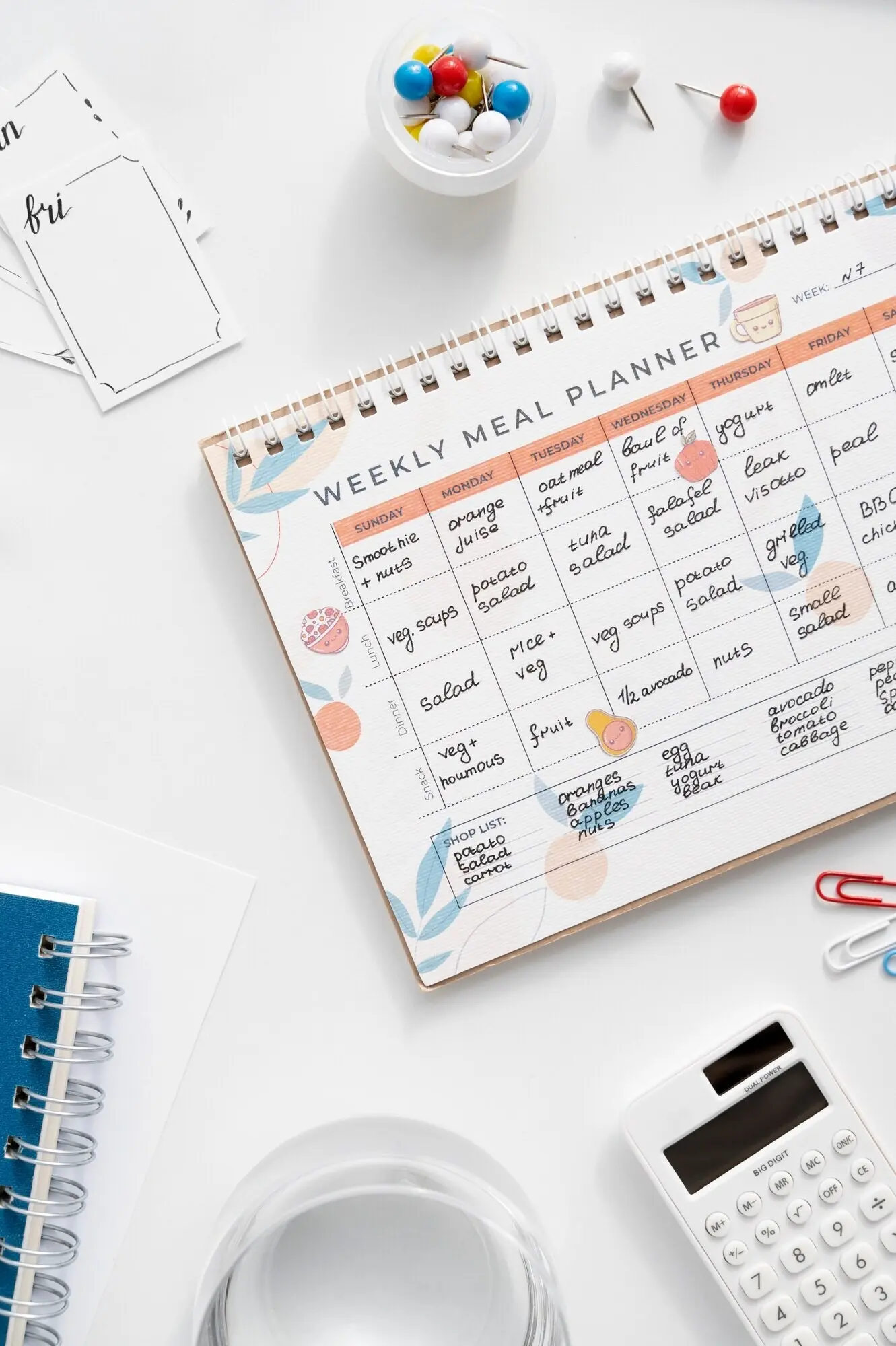 A still life depicting a colorful, overstuffed bullet journal.